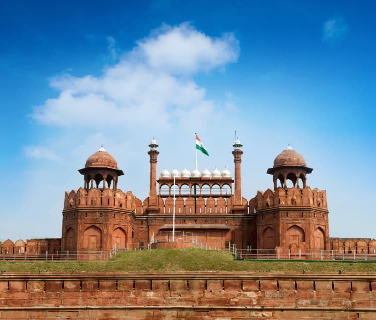 India Red Fort with Indian flag flying under blue sky
